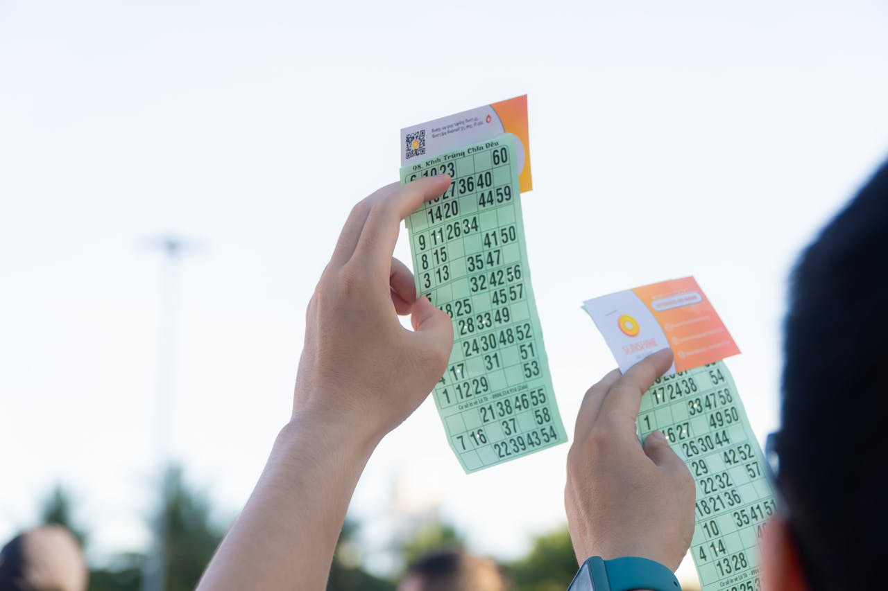 Services Close-up of hands holding transportation tickets, showcasing numbers and fare details.