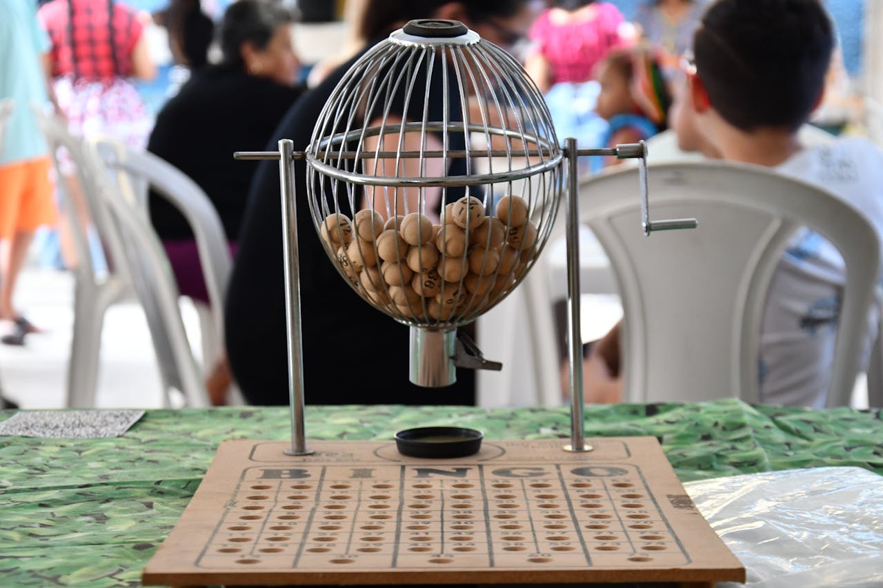 Services Close-up of a bingo cage with numbered balls and board, ready for play.
